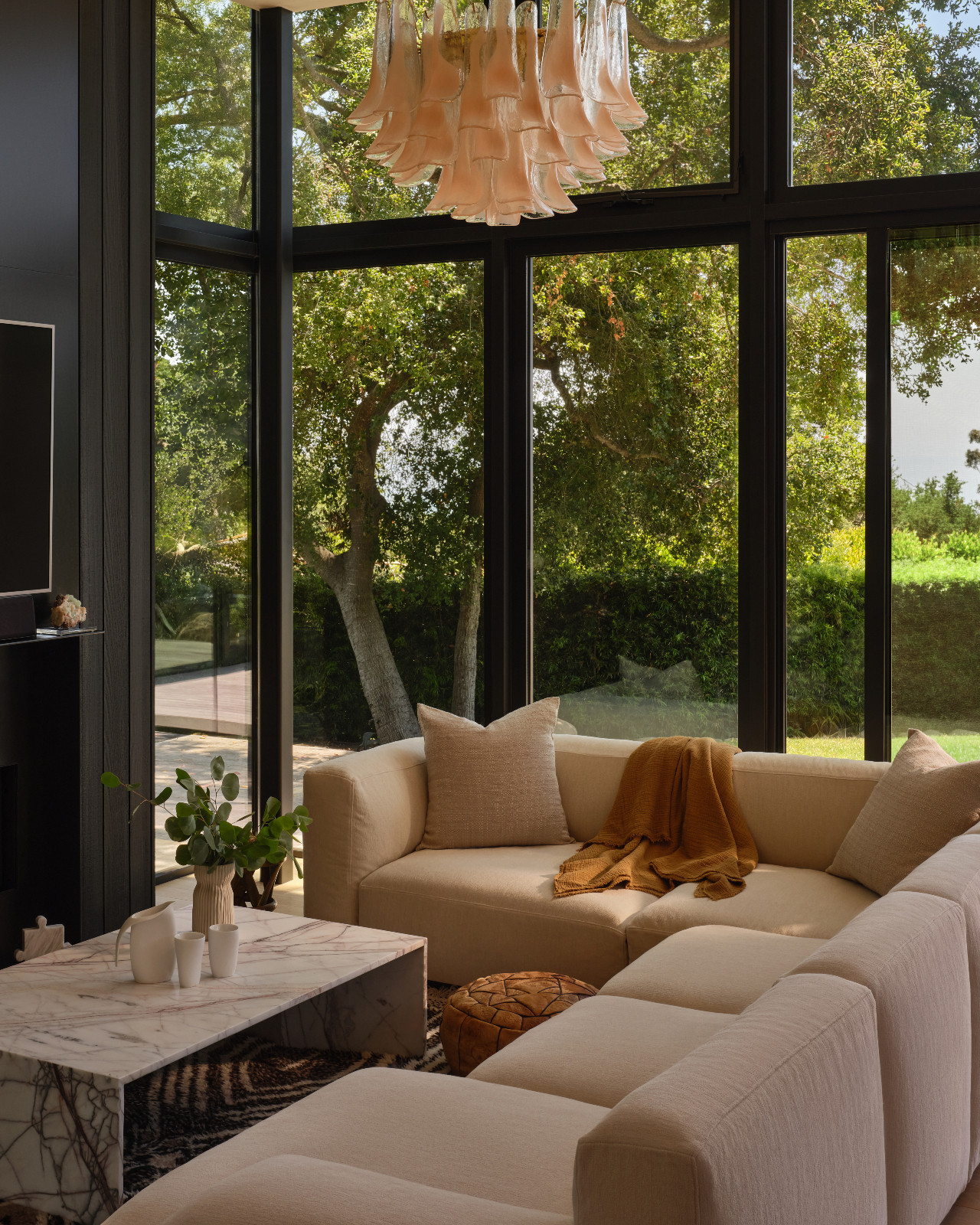 Floor-to-ceiling windows create a seamless flow between the indoors and outdoors in this Montecito, California home designed by Tamara Honey with AB Design Studio