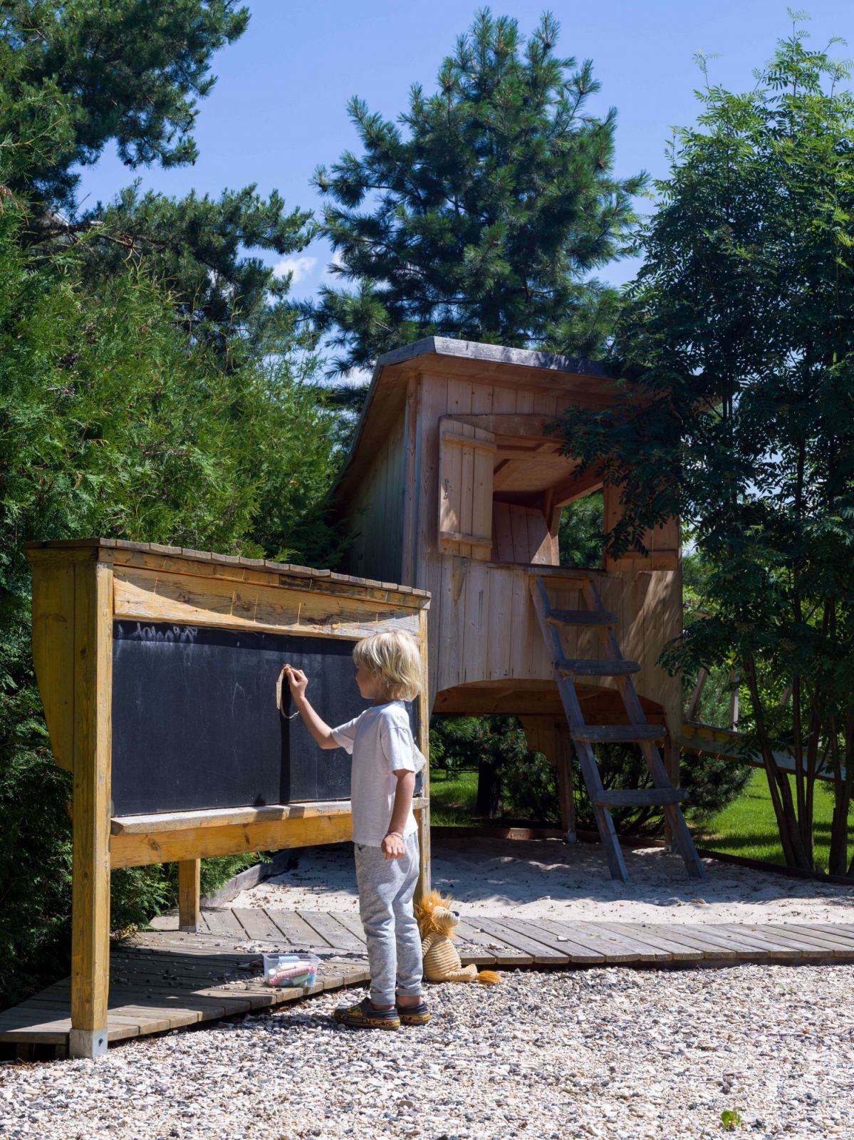 The kids’ outdoor play area with a small wooden house in the expansive back garden (Photo: Sergey Krasyuk)