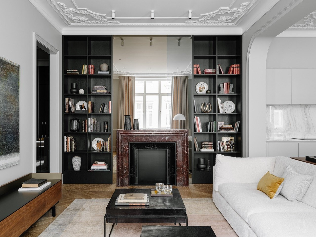 The living room library with custom-designed dark shelving flanking a marble fireplace with cast iron insert (Photo: Mikhail Loskutov)