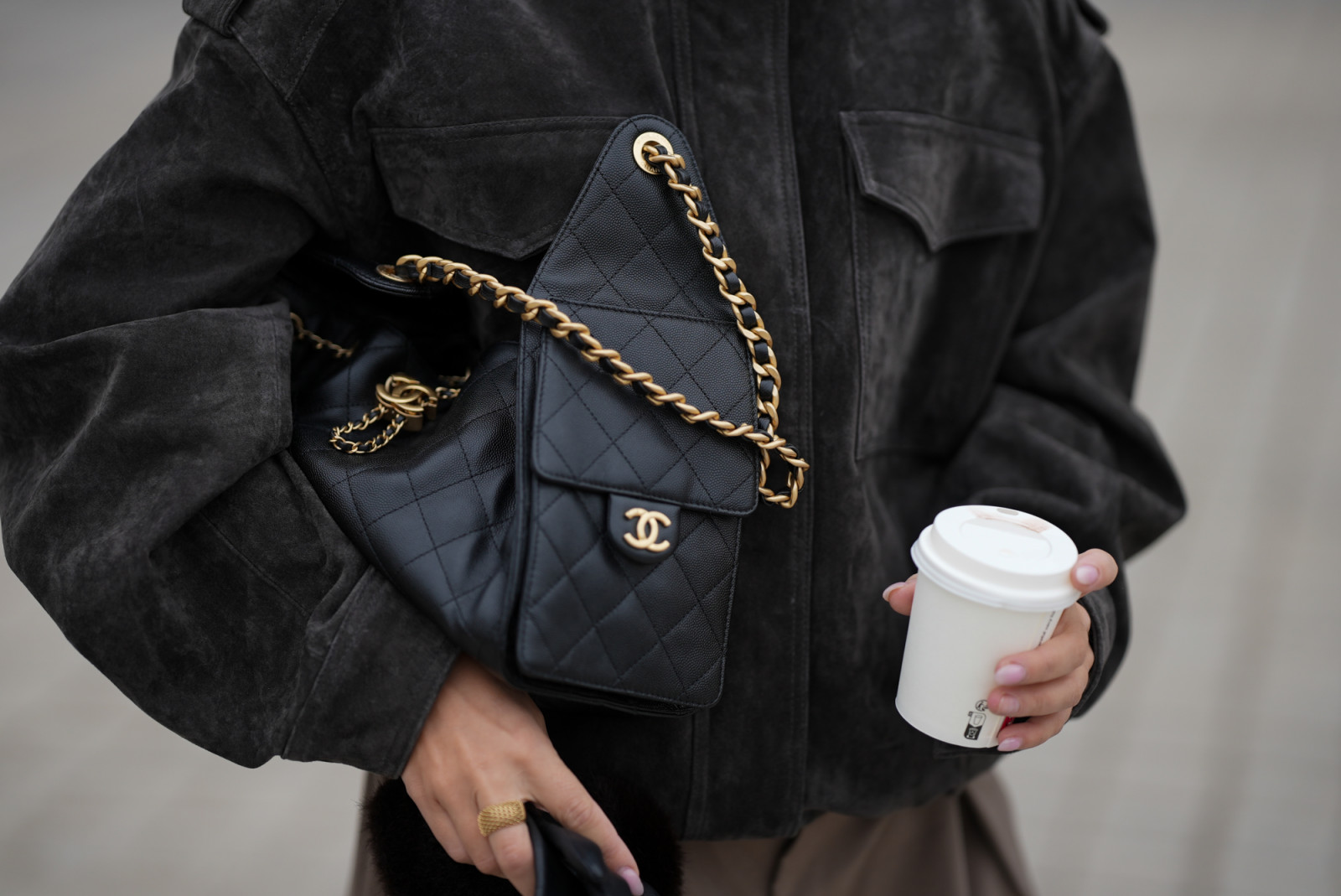 PARIS, FRANCE - OCTOBER 3: Anna Wein is seen wearing an oversized dark charcoal suede bomber jacket with wide shoulders, a high stand-up collar and large flap pockets from Zara; a classic quilted Chanel 25 medium handbag in black leather with gold chain strap and logo detail from Chanel during the Womenswear Spring Summer 2026 as part of Paris Fashion Week on October 3, 2025 in Paris, France. (Photo by Moritz Scholz/Getty Images)