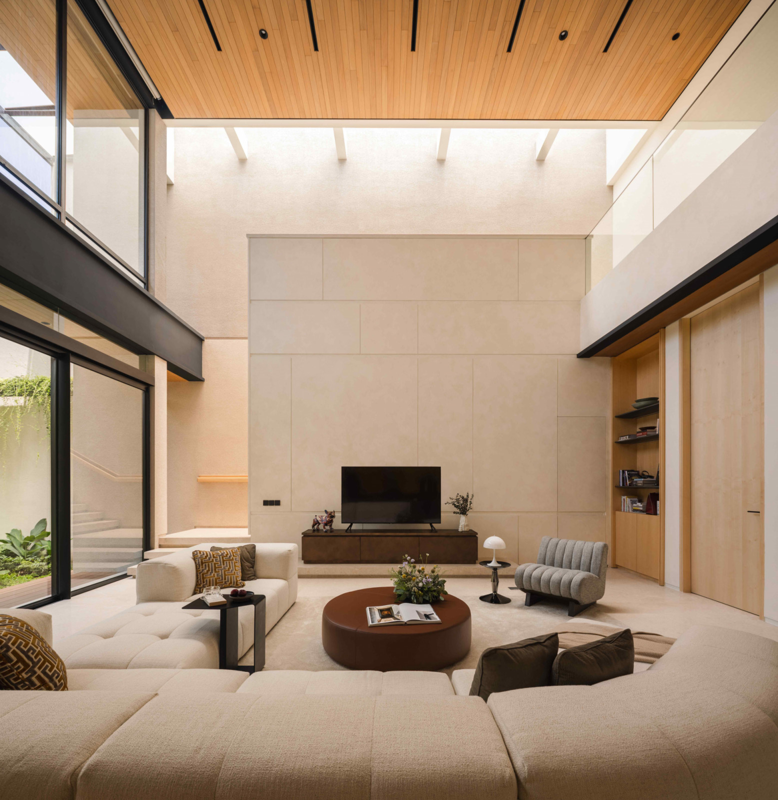 The double-height living room in the rear extension with large glass openings