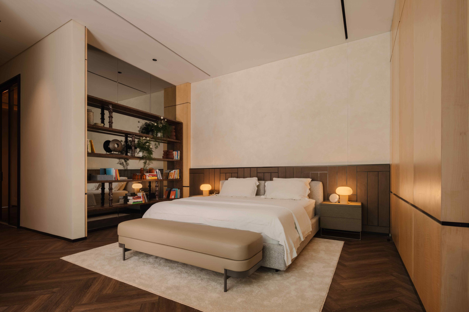 In the master bedroom, lighter tones of oak and cream marble create a subdued calmness