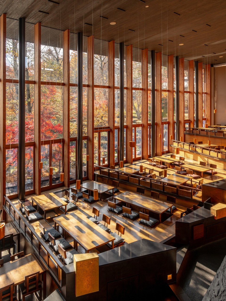 Local wood forms the structure at Kasuke, with the double-height space and extensive glazing creating a pavilion in a forest clearing rather than an enclosed room