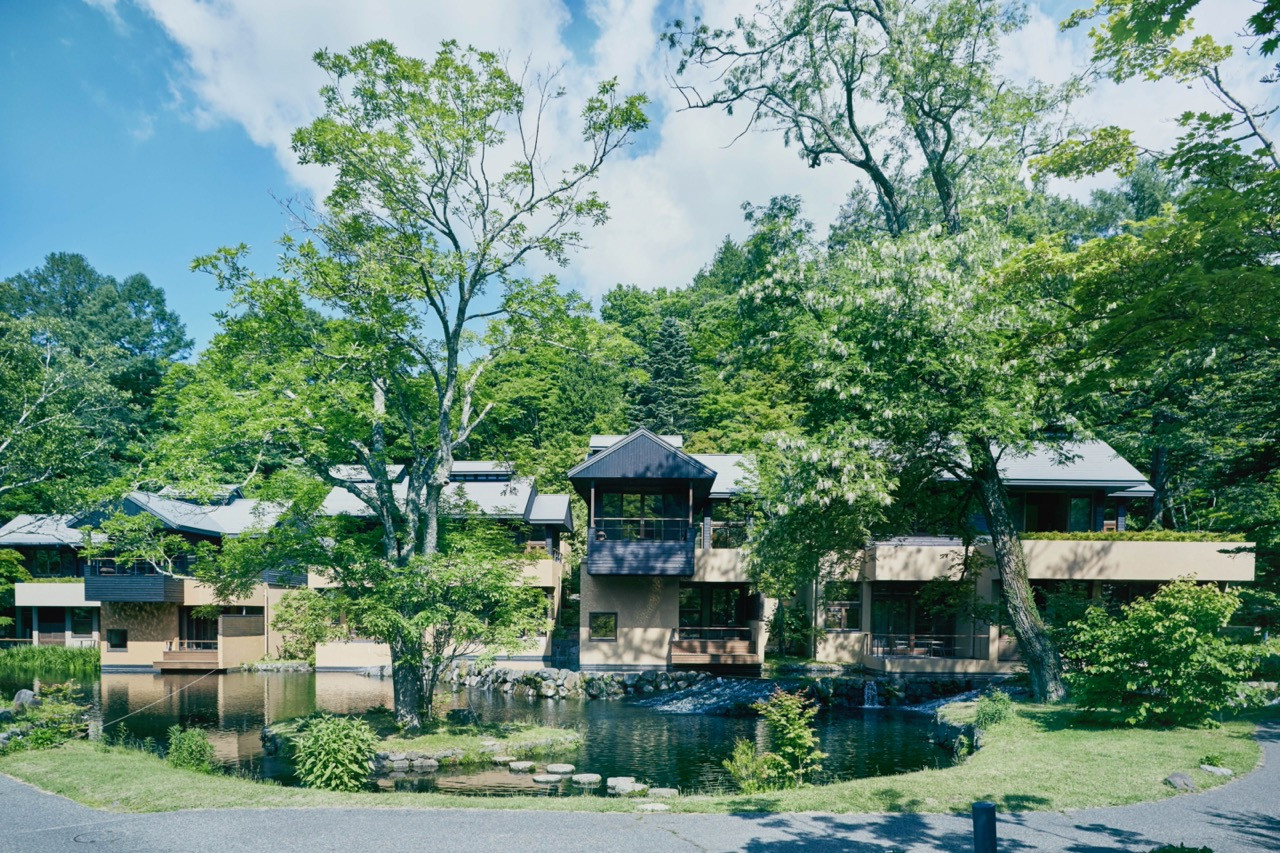 The resort reads as a village that settled gradually into the valley, with buildings and landscape integrated through two decades of natural growth