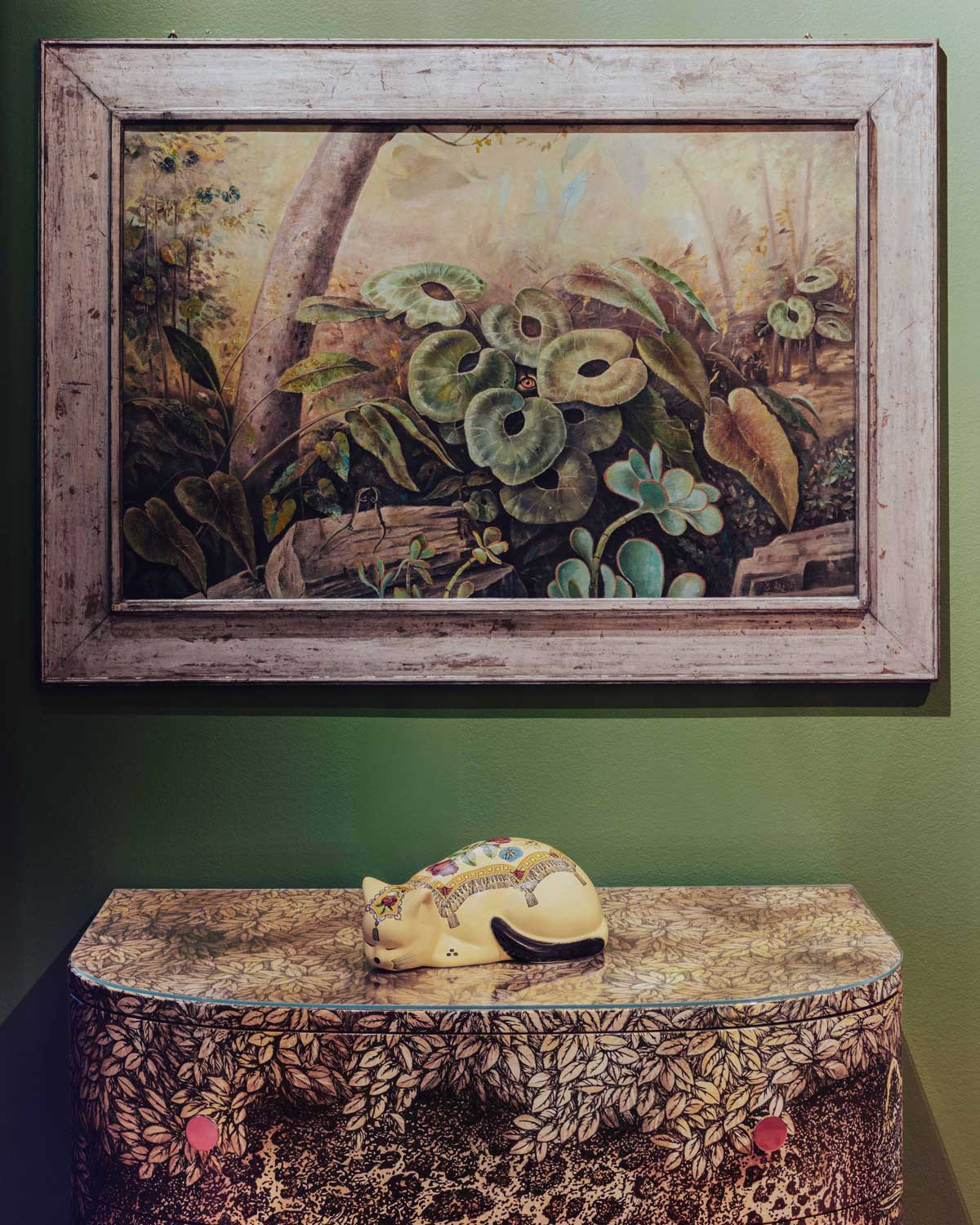 A sculpture of a sleeping cat displayed at the Fornasetti L’Heure du Chat exhibition