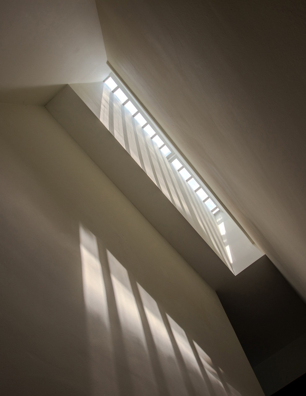 Natural light filters through the expanded central lightwell, which was reopened and doubled in size from the original sealed-off service airwell