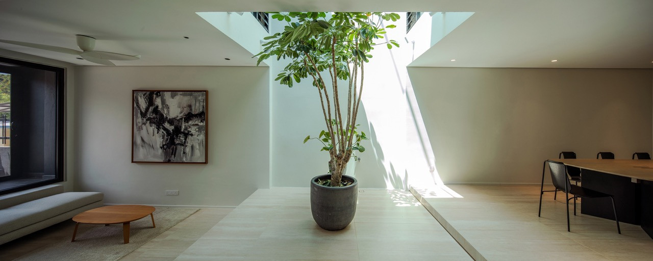 The sunken living area sits adjacent to the expanded lightwell, with the Kato sofa by King Living reinforcing the floating mass concept