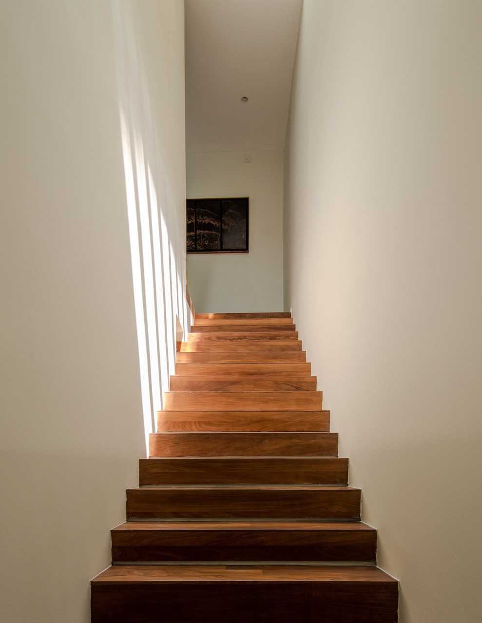 Solid satin wood stairs from Lumbermart feature the recessed skirting detail that creates the impression of floating masses throughout the house
