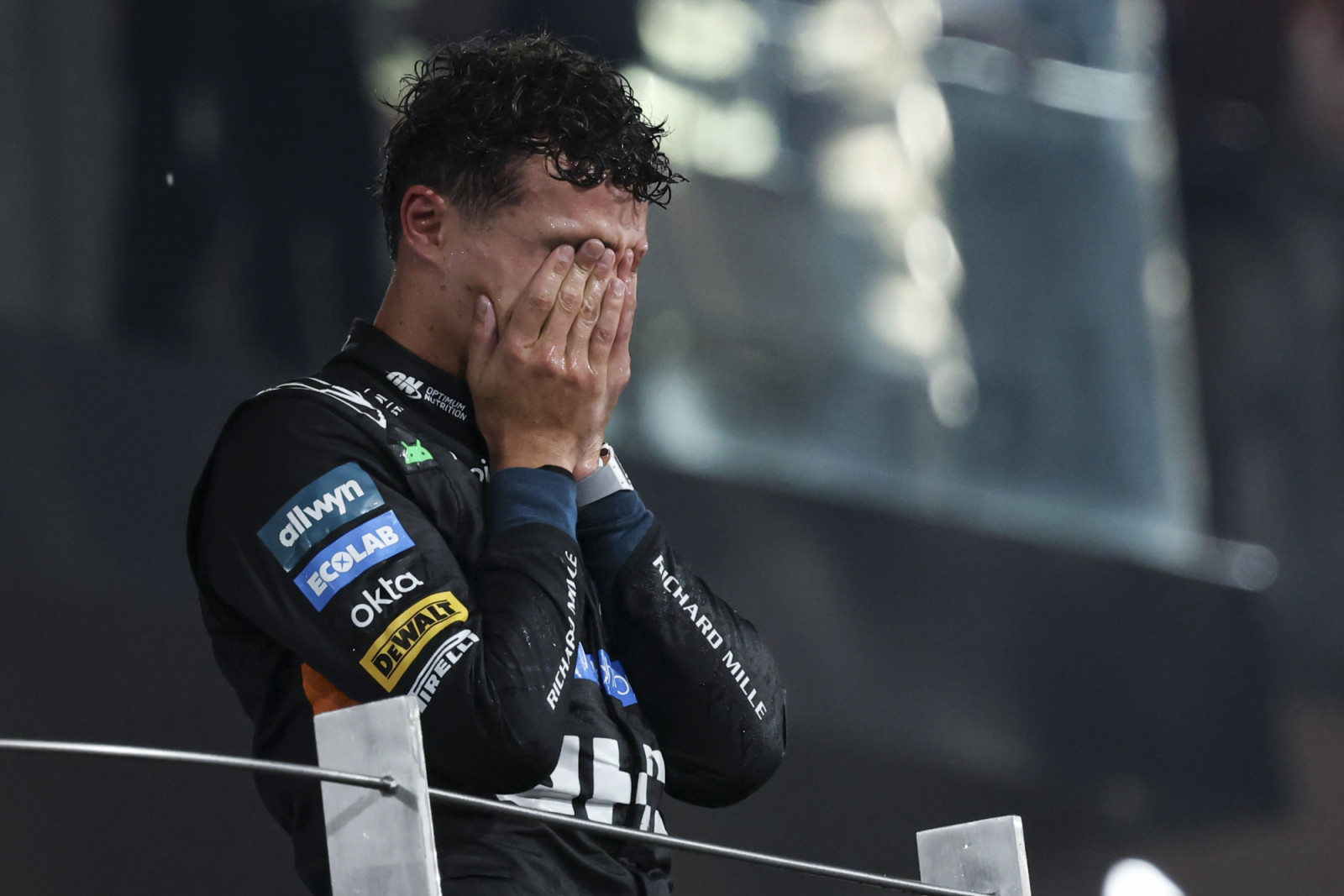 The new F1 world champion Lando Norris of United Kingdom driving the F1 race car No 4, the McLaren MCL39 for the McLaren Formula 1 Team, on the podium tearful celebrating the 2025 driver's championship his first F1 title after the season ending race of 2025 Formula 1 Etihad Airways Abu Dhabi Grand Prix at Yas Marina Circuit. Abu Dhabi, United Arab Emirates on December 7, 2025.  (Photo by Nicolas Economou/NurPhoto via Getty Images)