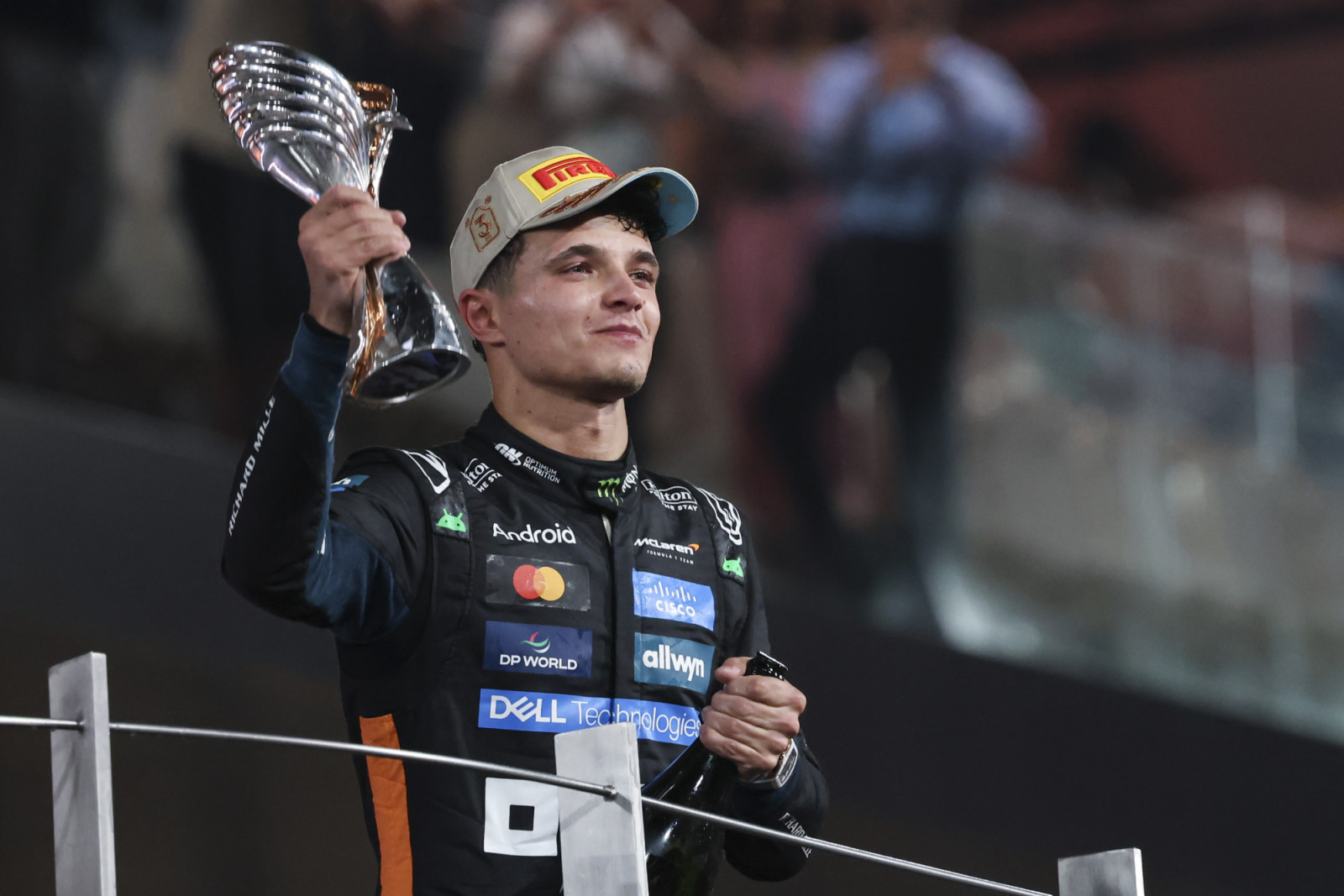 The new F1 world champion Lando Norris of United Kingdom driving the F1 race car No 4, the McLaren MCL39 for the McLaren Formula 1 Team, on the podium tearful celebrating the 2025 driver's championship his first F1 title after the season ending race of 2025 Formula 1 Etihad Airways Abu Dhabi Grand Prix at Yas Marina Circuit. Abu Dhabi, United Arab Emirates on December 7, 2025.  (Photo by Nicolas Economou/NurPhoto via Getty Images)