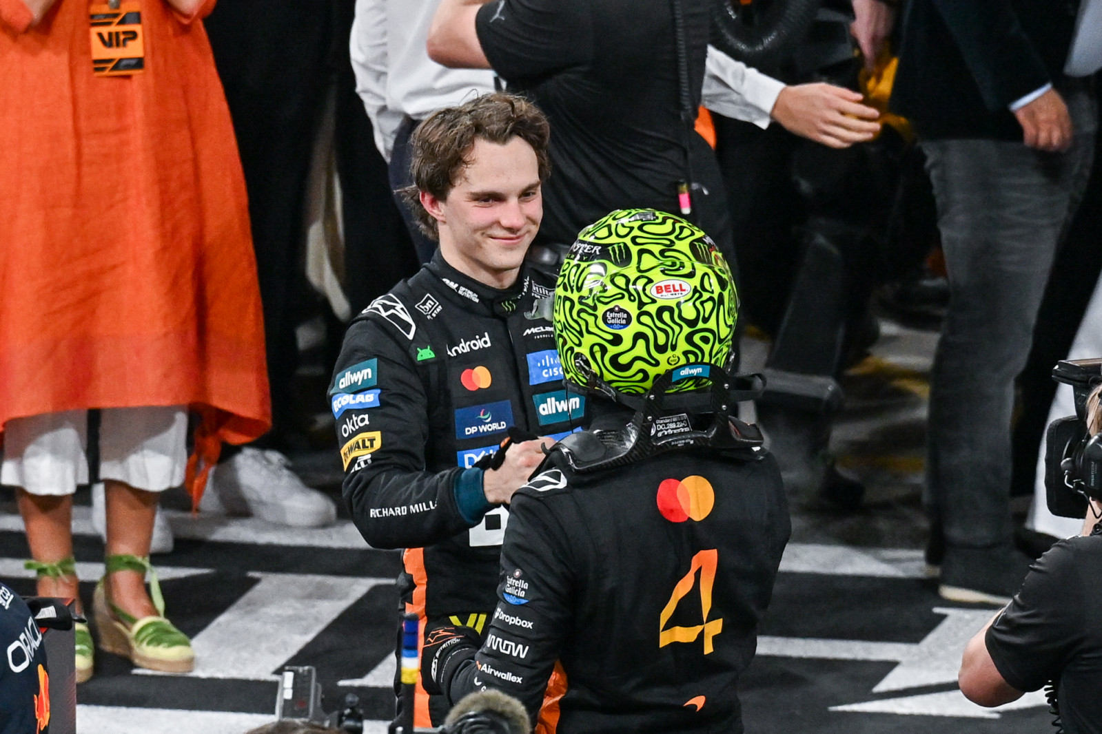 ABU DHABI, UNITED ARAB EMIRATES - DECEMBER 07: British driver Lando Norris (R) of the McLaren team, who finished F1 Abu Dhabi Grand Prix in the 3rd place and Australian driver Oscar Piastri of McLaren (L) in the 2nd greet each other at Yas Marina Circuit, in Abu Dhabi, United Arab Emirates on December 7, 2025. (Photo by Waleed Zein/Anadolu via Getty Images)