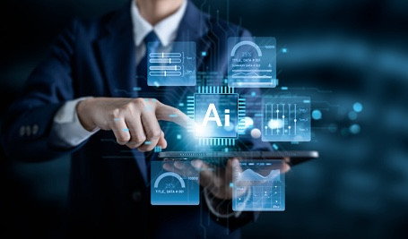 Businessman using digital tablet with AI icon and data analytics interface. Concept of artificial intelligence, big data, machine learning, innovation and digital transformation in technology business (ภาพ: Pornpimone Audkamkong / Getty Images)