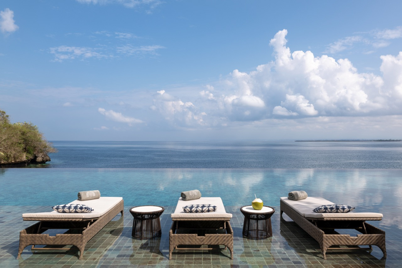The resort’s infinity pool offers sweeping ocean views across Jimbaran Bay