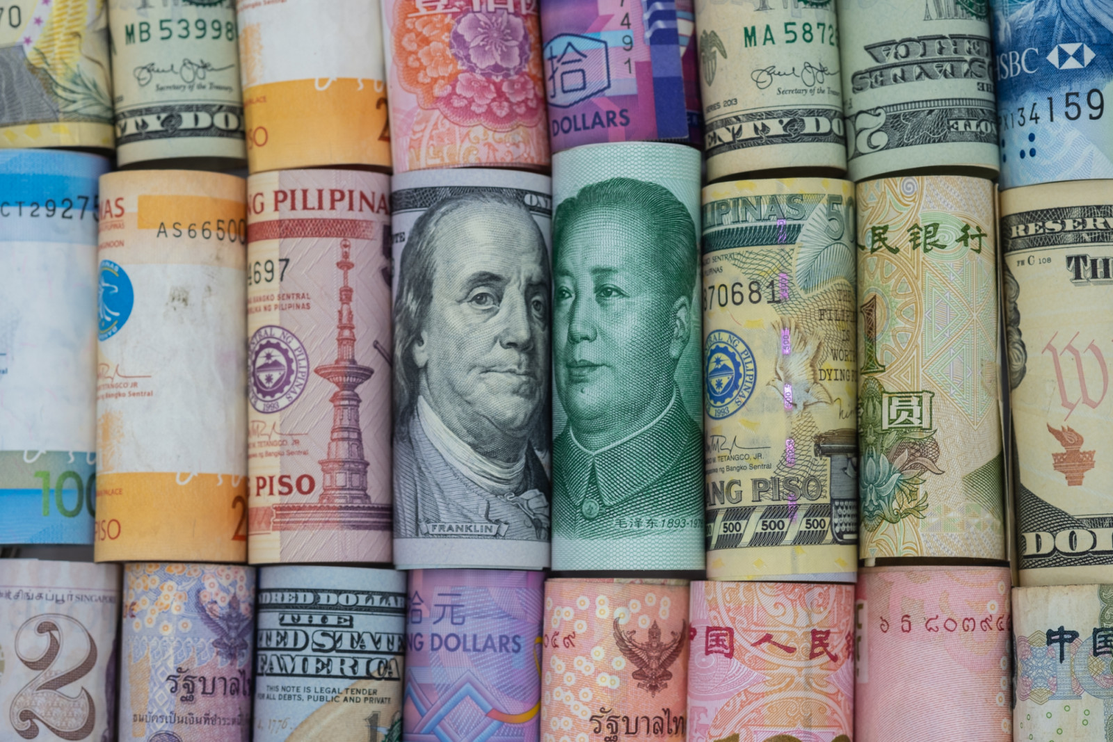 US dollar and China Yuan banknote with multi countries banknotes. Its is symbol for tariff trade war crisis or unfair business of 2 biggest economic countries in the world. (ภาพ: Dilok Klaisataporn / Getty Images)