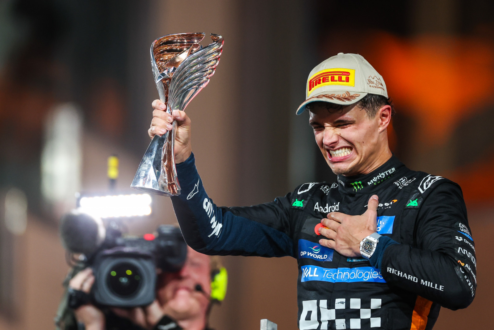 ABU DHABI, UNITED ARAB EMIRATES - DECEMBER 7: Lando Norris of Great Britain and McLaren raises his trophy in celebration on the podium during the F1 Grand Prix of Abu Dhabi at Yas Marina Circuit on December 7, 2025 in Abu Dhabi, United Arab Emirates. (Photo by Jayce Illman/Getty Images)
