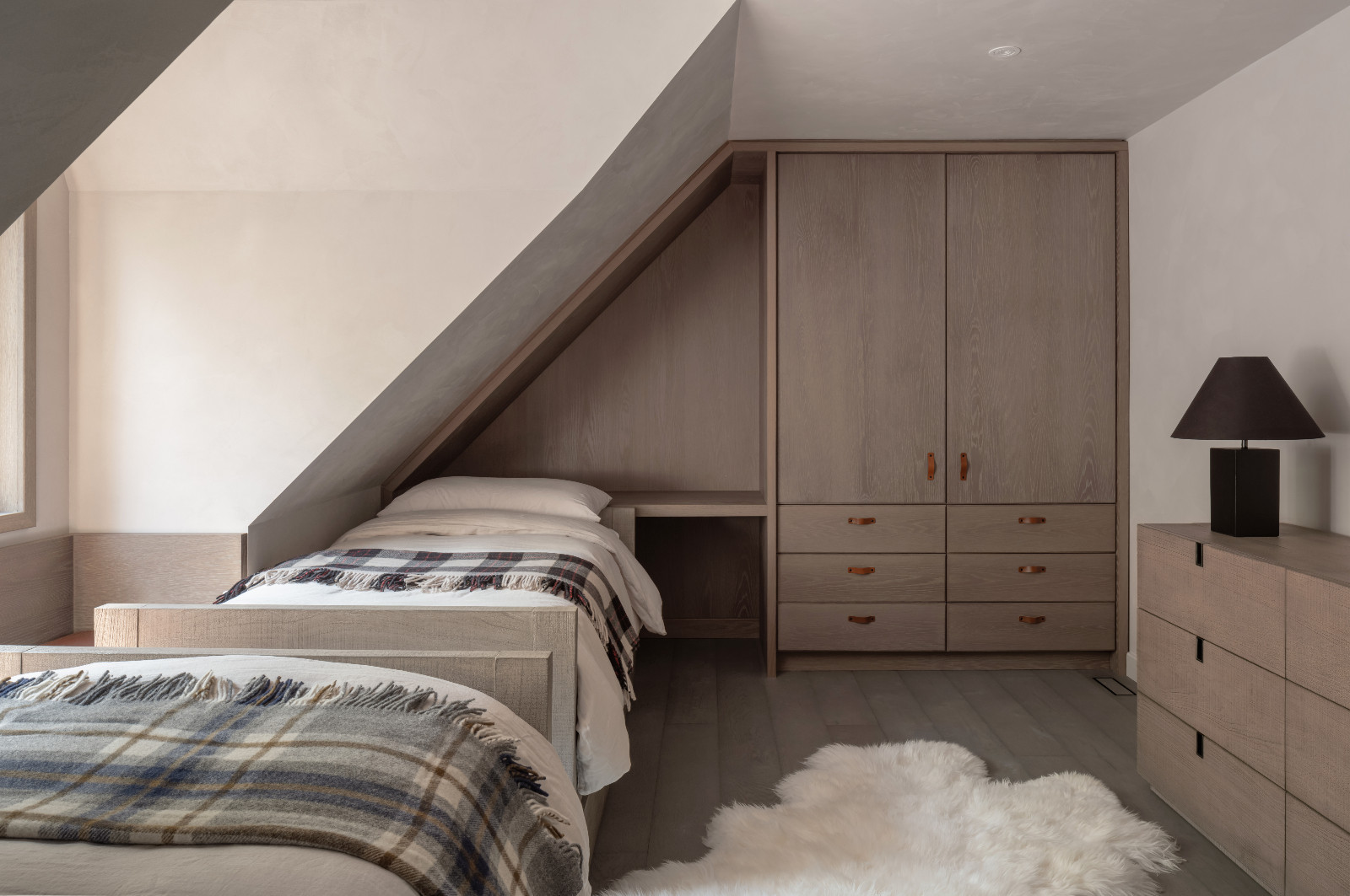 The guest bedroom of a renovated ski chalet in Quebec, Canada, designed by ACDO