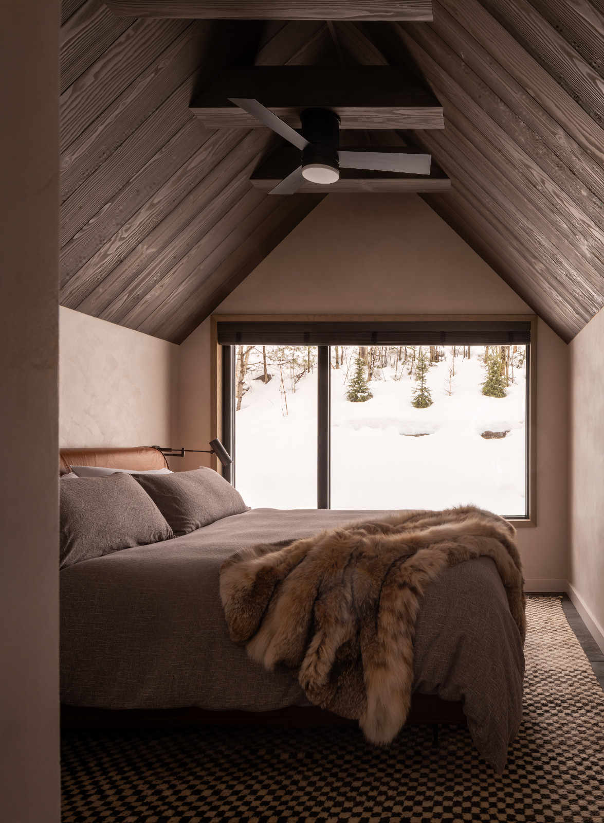 The bedroom of a renovated ski chalet in Quebec, Canada, designed by ACDO