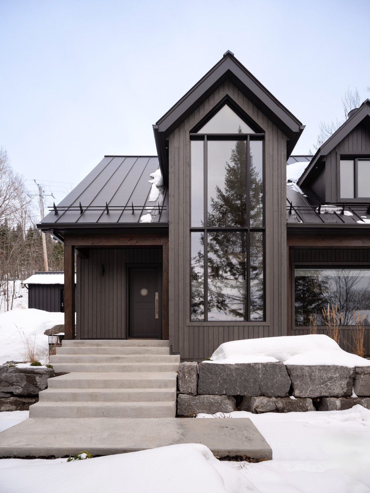 The exterior of a renovated ski chalet in Quebec, Canada, designed by ACDO