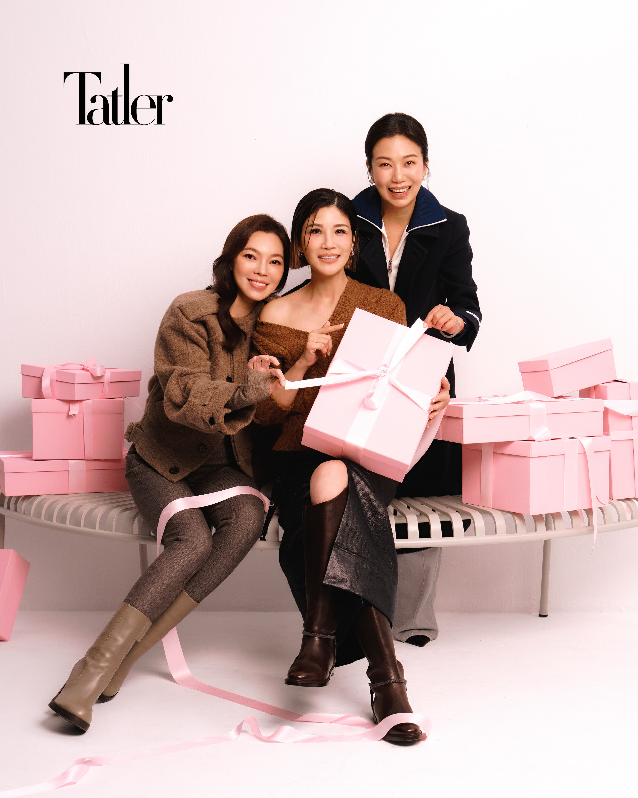 曾馨瑩:駝色針織衫、短版大衣外套、棕色條紋緊身褲 all by Burberry;高跟短靴 by Tod's。蔣雅淇:棕色 V 領針織上衣 by Loewe; 黑色開衩皮裙 by Shiatzy Chen;棕色皮長靴 by Burberry。林有慧:高領長大衣外套、牛仔長褲 Both by Prada。格柵公園凳 by Hay。Photo: Chuan Chou