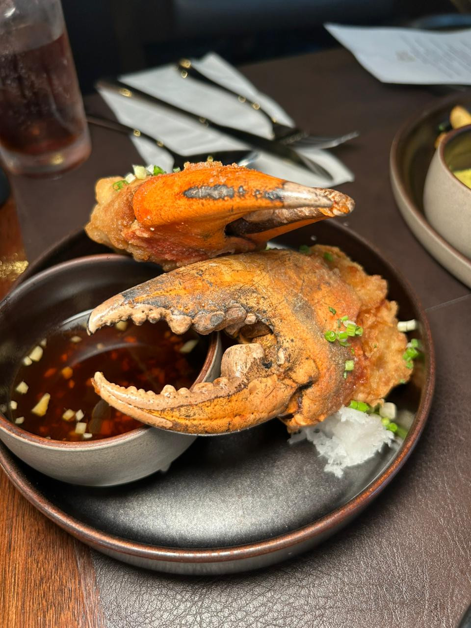 Crab claw- blue crab claws cooked tempura-style, coated in an airy batter and fried, then served with grated radish and a soy-dashi dipping sauce | Photo: Jaclyn Koppe