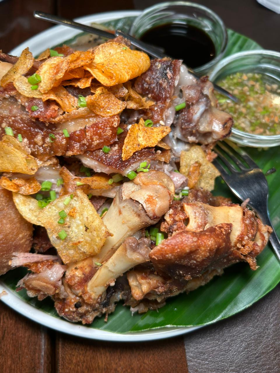 Crispy pork knuckle- deep fried pork knuckle that is extra crispy on the outside, while gelatinous and tender on the inside. Served with soy calamansi, crispy potato, and spiced vinegar dipping sauce | Photo: Jaclyn Koppe