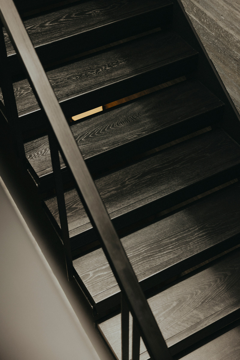 Detail of the stairs, featuring dark-washed timber that still flaunts its grains