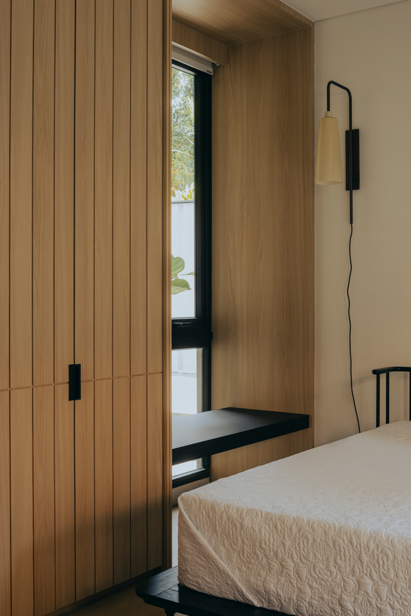 A depth adjacent to the wardrobe has been transformed into a multipurpose surface