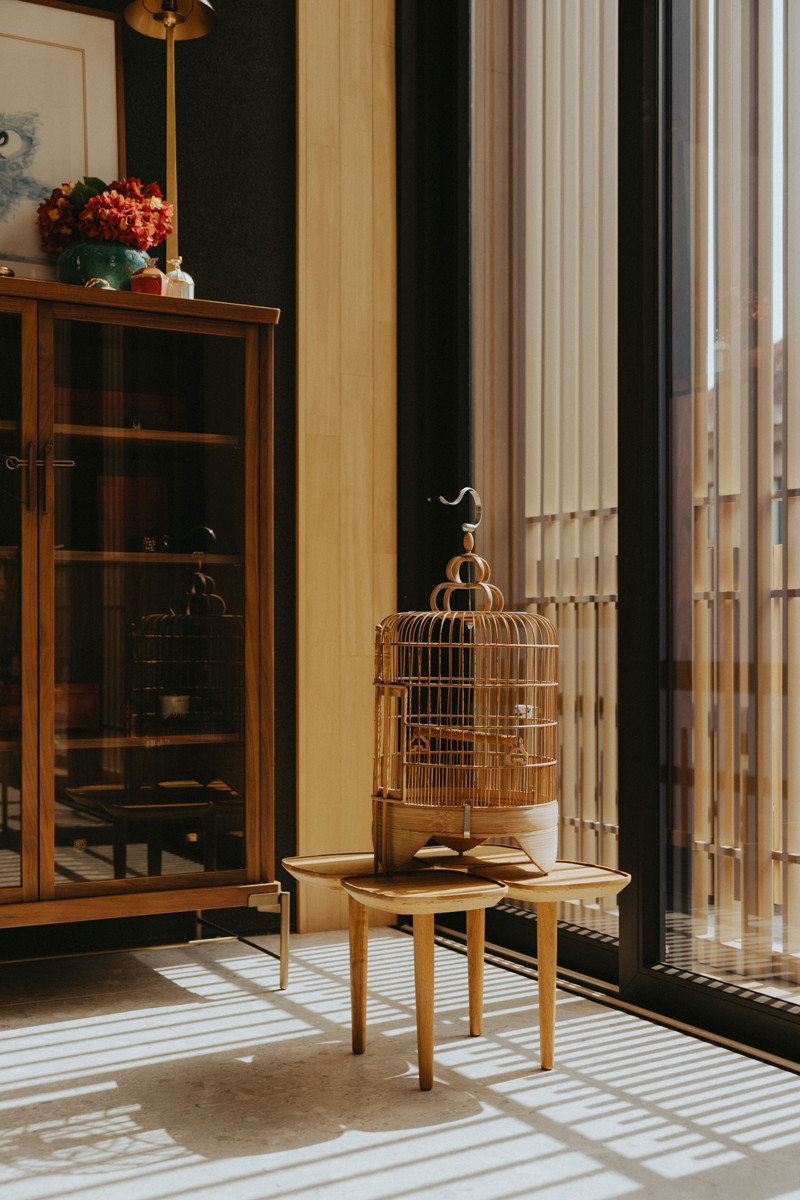 Displayed atop coffee table, this birdcage paints a poetic shadowplay as the day progresses