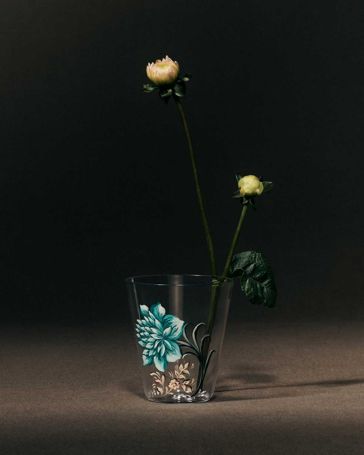 A glass cup with botanical motifs
