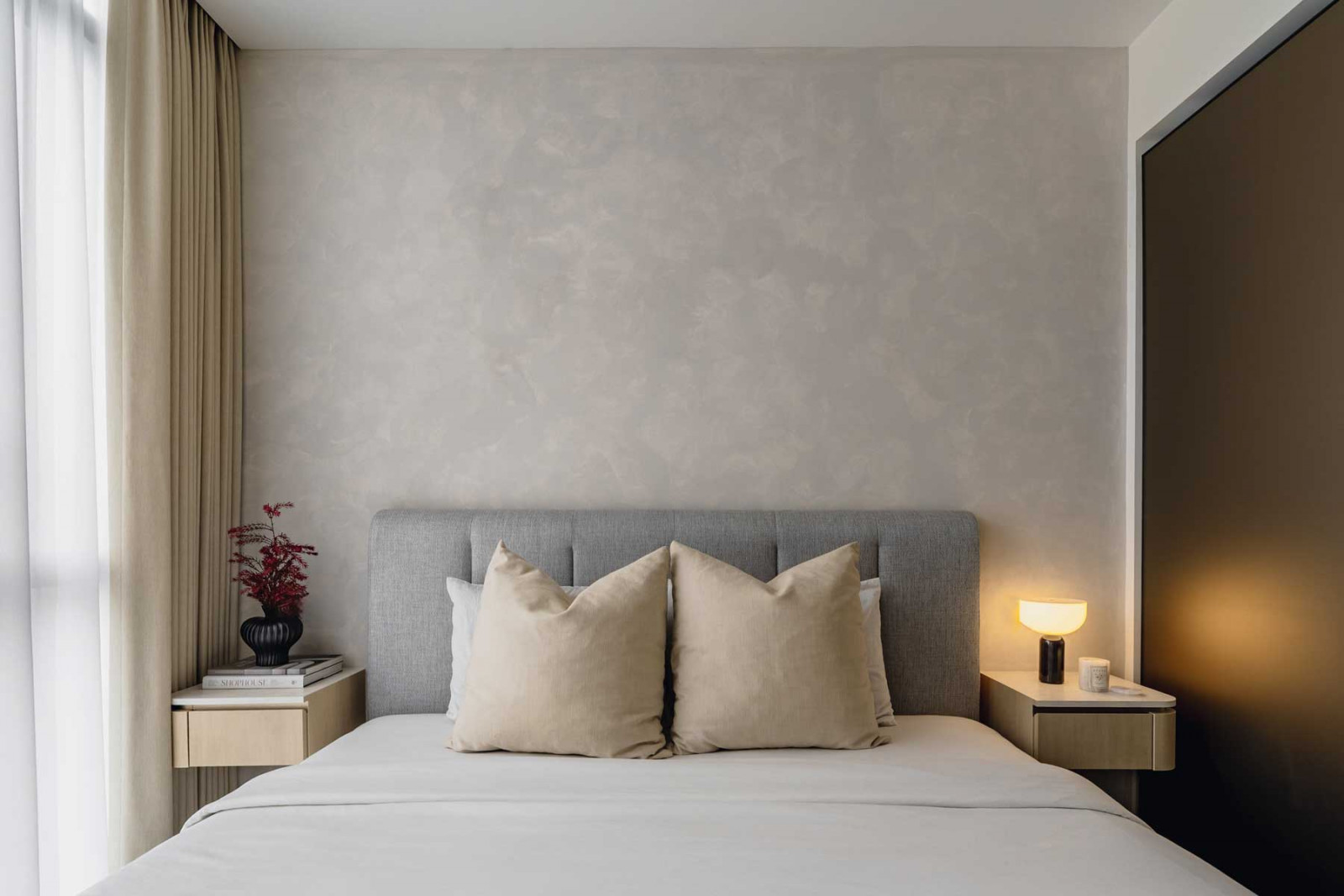 The master bedroom is a peaceful retreat that celebrates sedate hues and comfy textiles