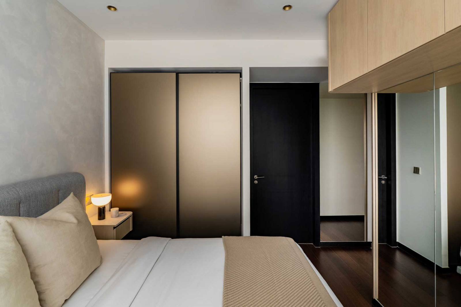 Textured special-effects wall paint, coupled with a matte finish on the wardrobe doors, add to the tactile look of the master bedroom