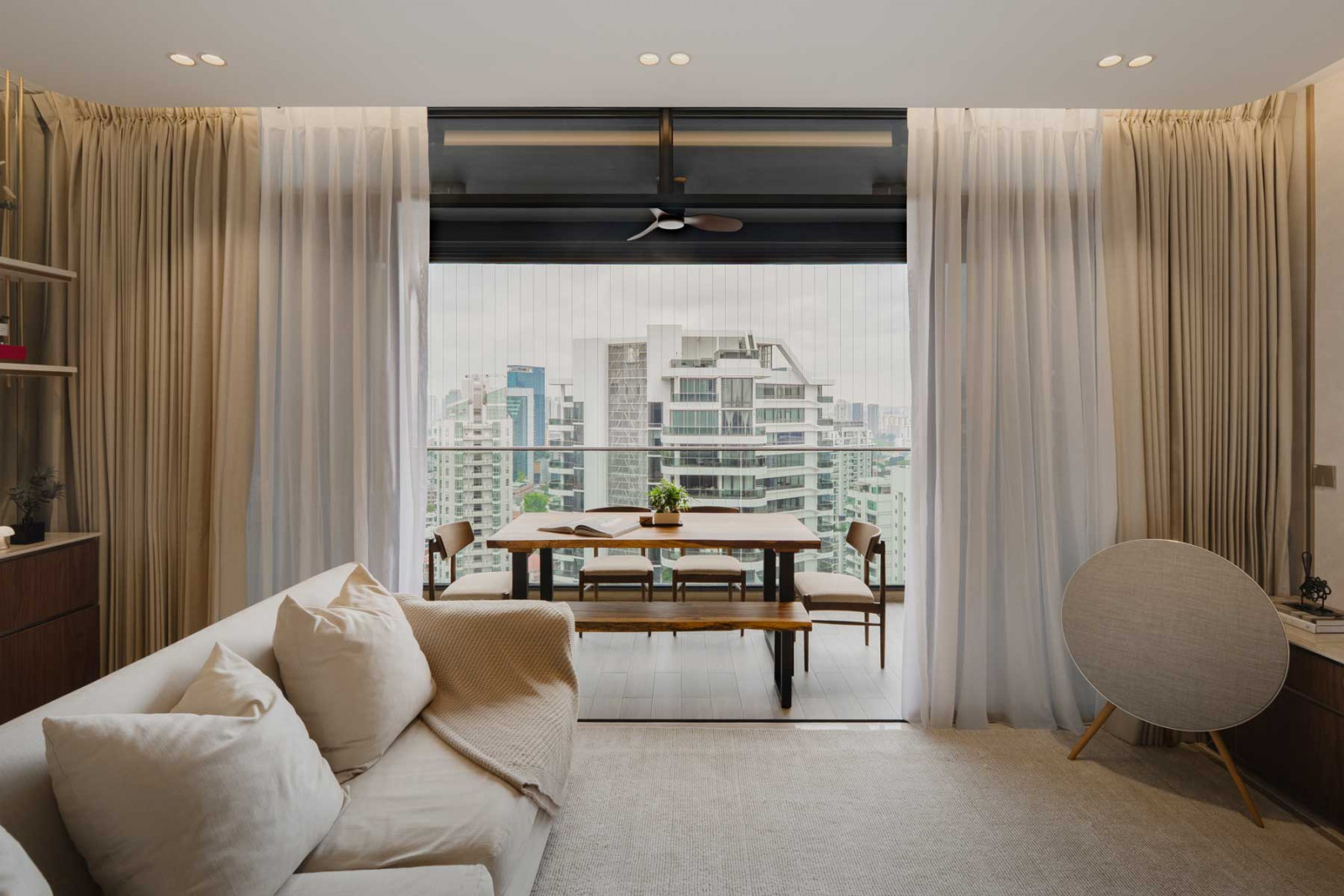 The balcony is thoughtfully utilised as an extension of the compact living area with an outdoor table and seating