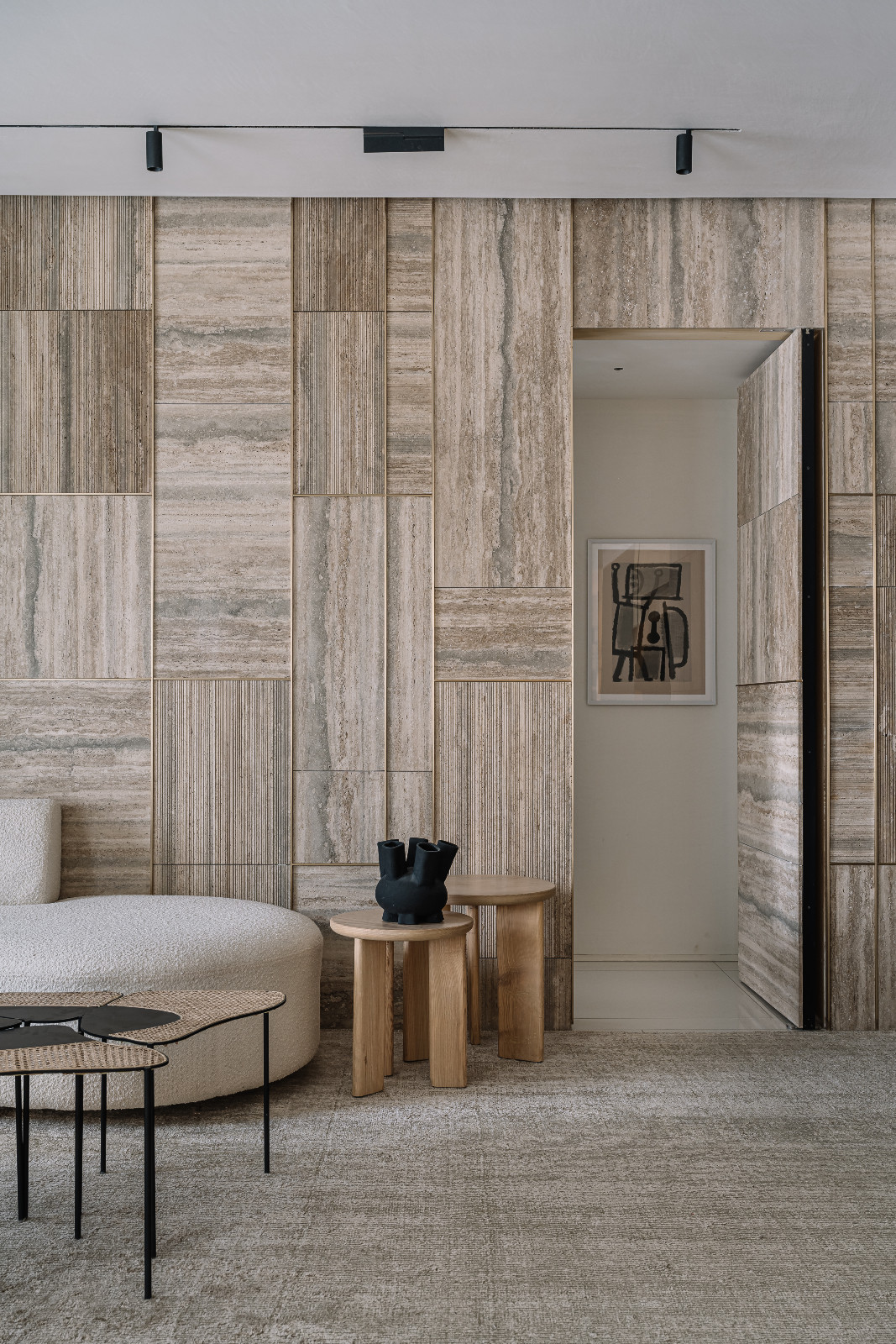 A Japandi-inspired living room leading to a bedroom in an Ahmedabad, India, home designed by Workshop Inc.