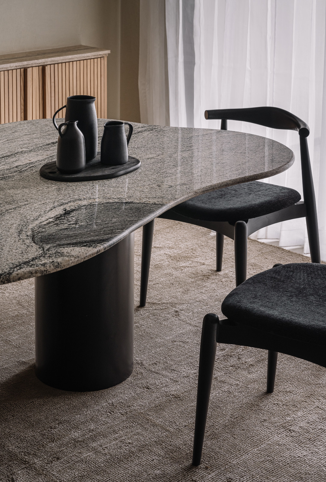 A Japandi-inspired dining room in an Ahmedabad, India, home designed by Workshop Inc.