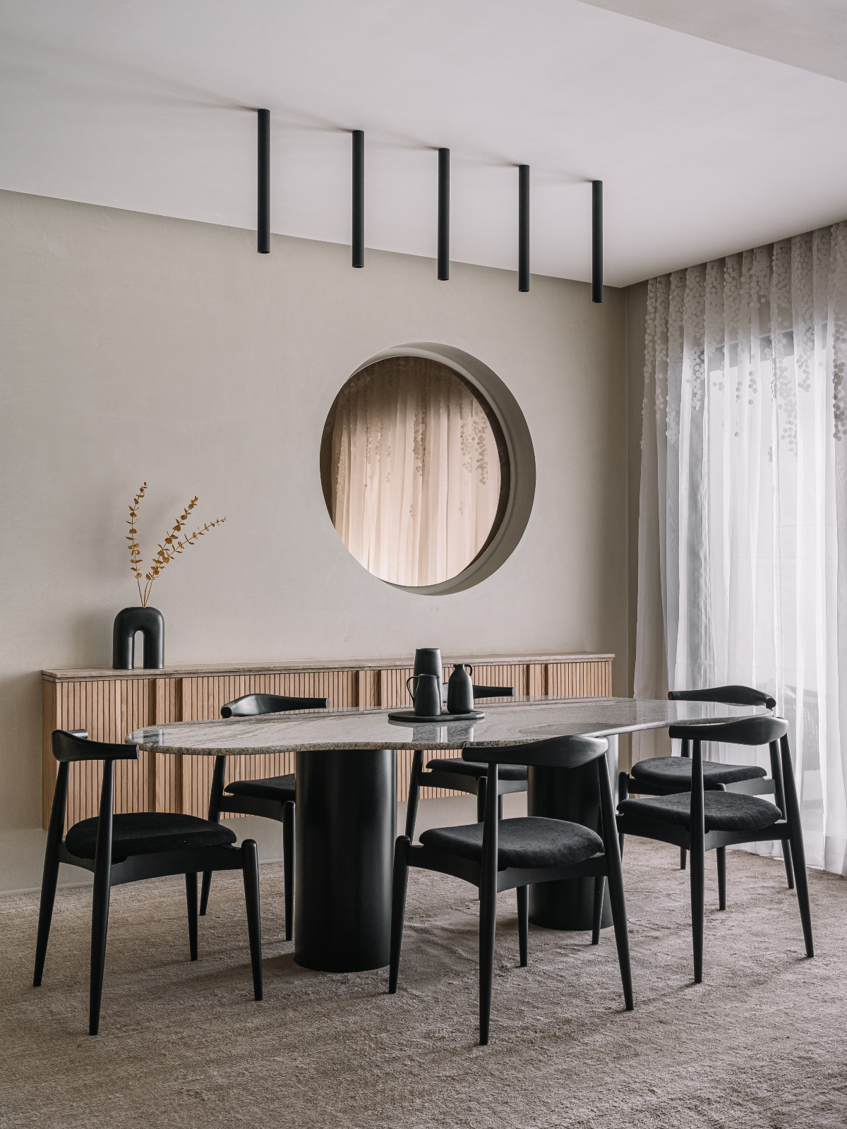 A Japandi-inspired dining room in an Ahmedabad, India, home designed by Workshop Inc.