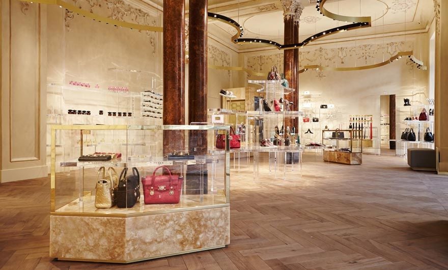 Jamie Fobert’s contemporary interventions include marble plinths, brass detailing, and transparent plexiglass shelving (Photo: Versace)