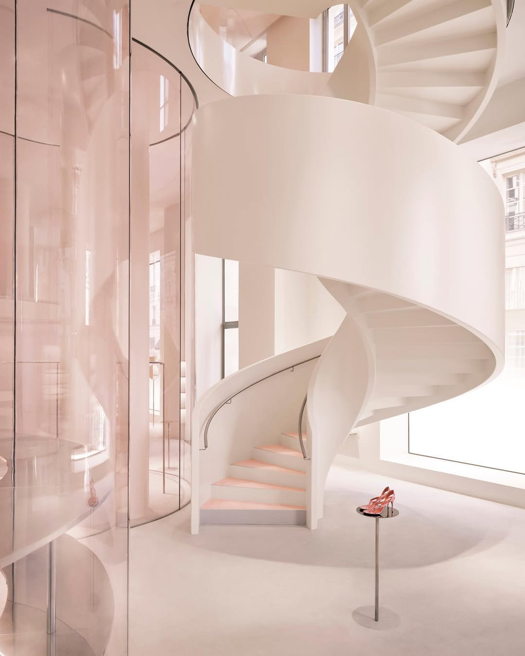 The sculptural spiral staircase echoes the brand’s sinuous forms (Photo: Instagram / @maisonalaia)