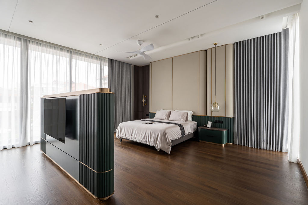 The master suite demonstrates how the custom curved television console divides the space without creating a wall