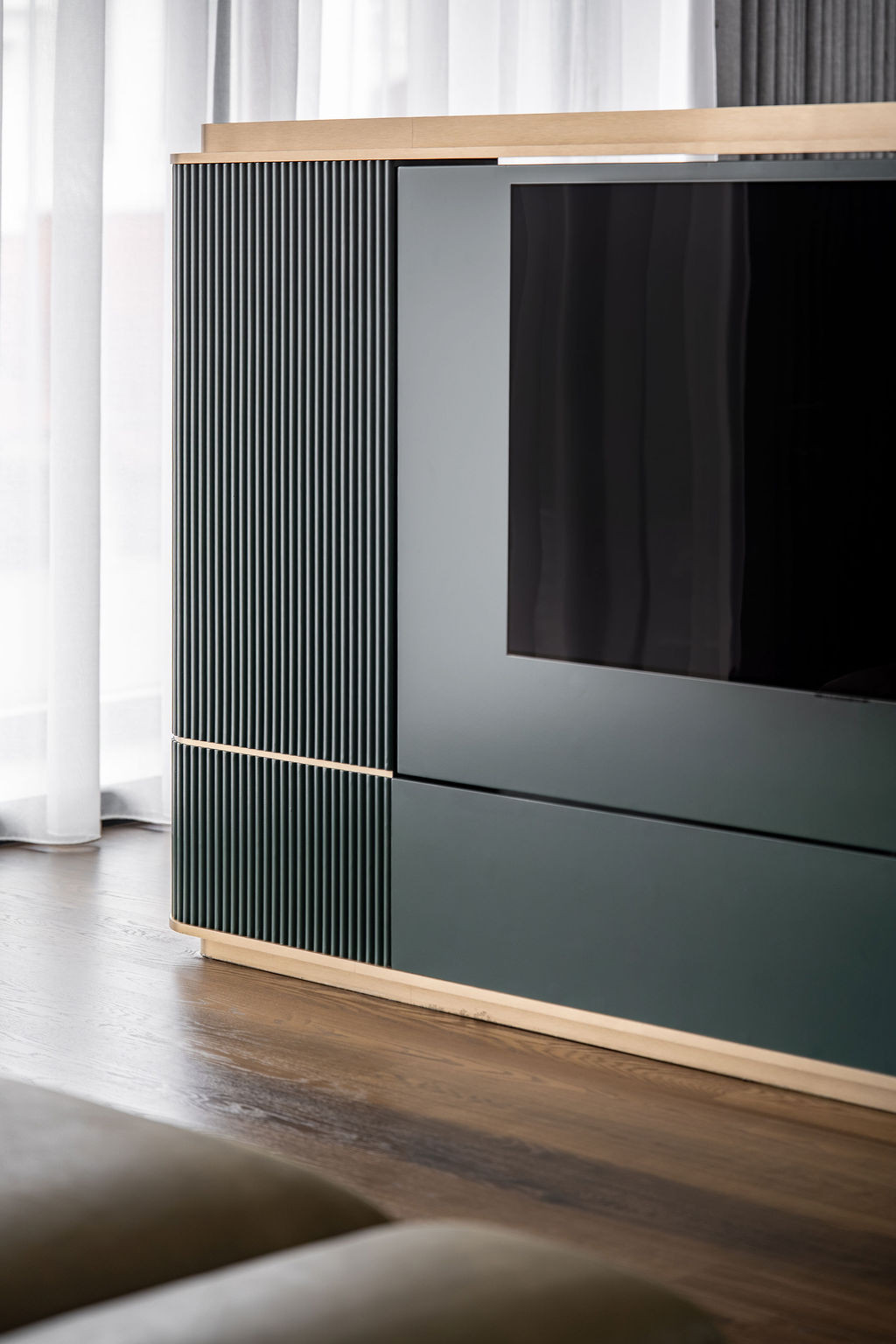 The master suite’s custom curved television console functions as both a media unit and spatial divider