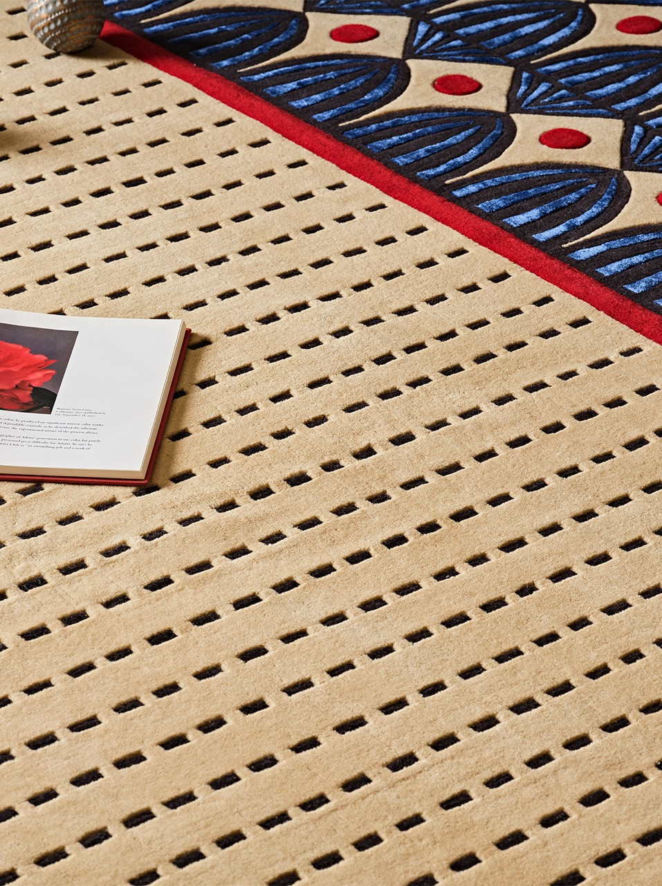 Butter/Butter draws from a popular Indian butter brand’s packaging, translating the distinctive wrapper design into a hand-knotted textile with blue fan motifs, red details and cream circular patterns