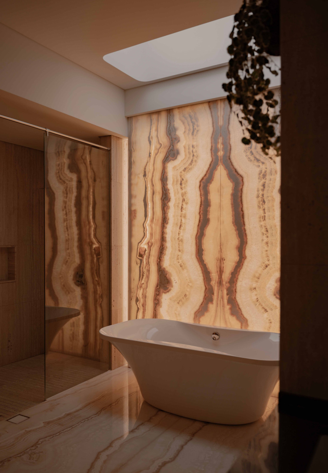 This bookmatched marble wall is backlit, allowing the stone’s veining to glow and lending the space a heightened sense of drama