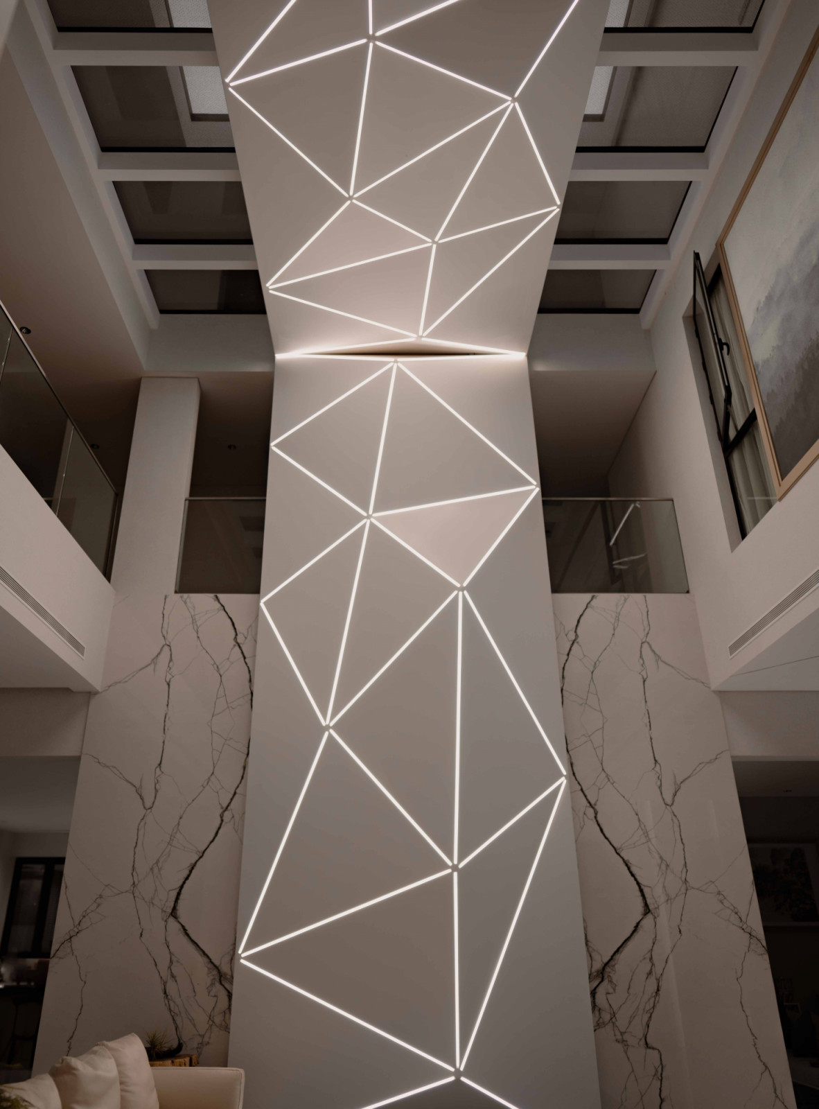 Close-up of the lighting installation, transforming a necessary support into a luminous, sculptural focal point