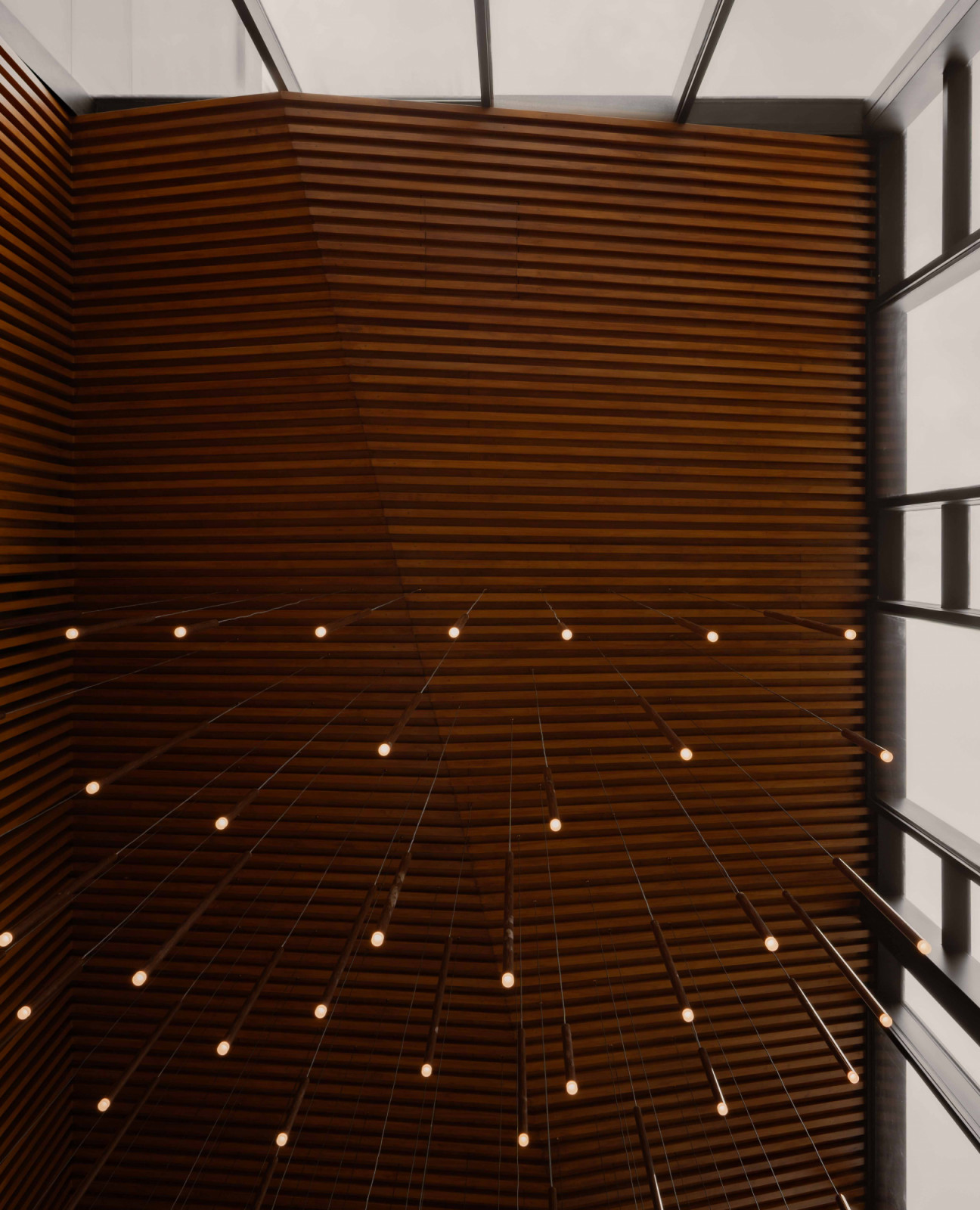 The entrance lighting installation transforms arrival into a quietly theatrical moment