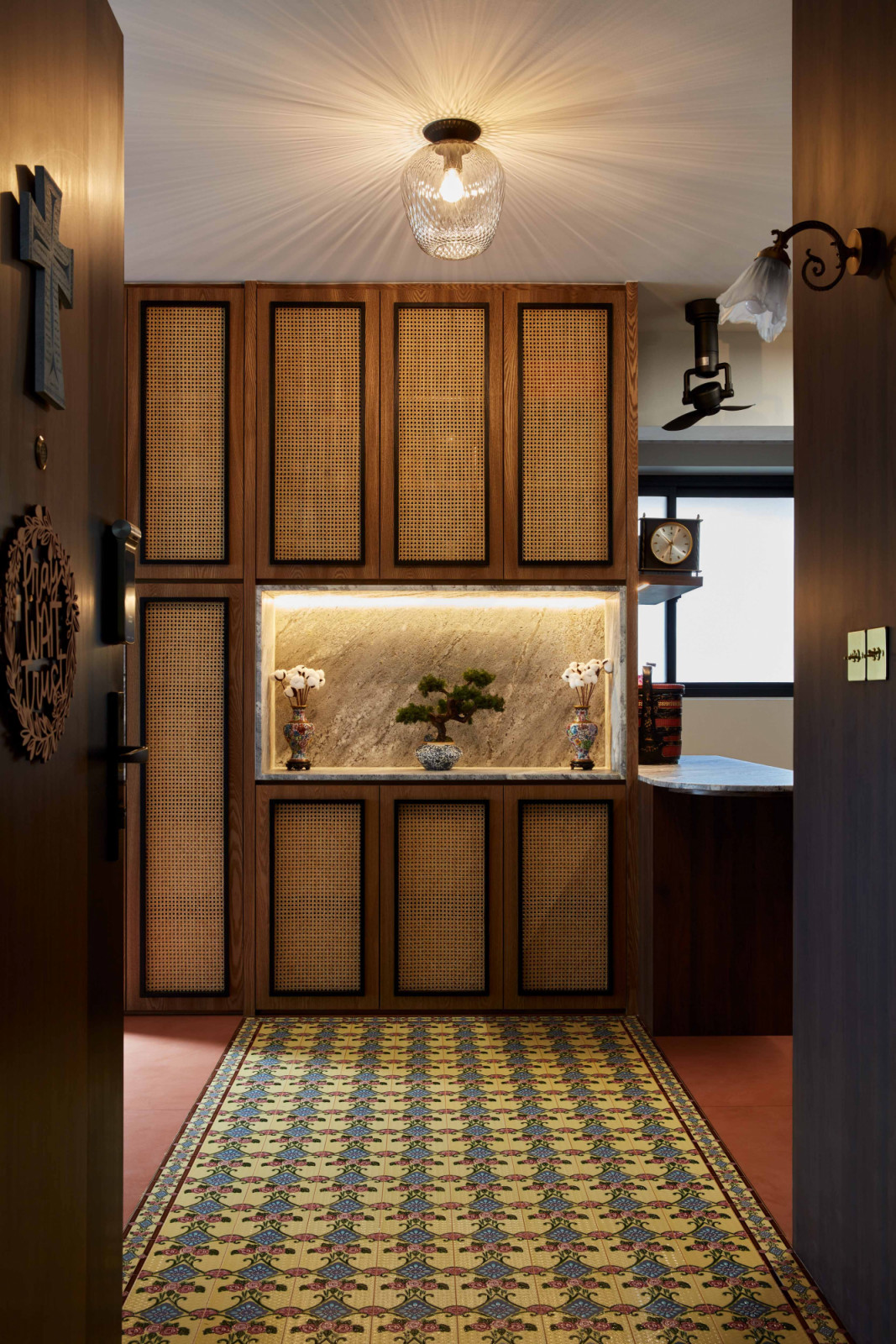 Patterned Peranakan tiles at the entryway offer a colourful welcome to the home