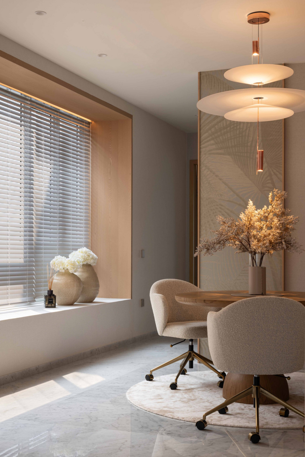 The secluded work area sports a muted, soft palette that feels light and refined in nature;