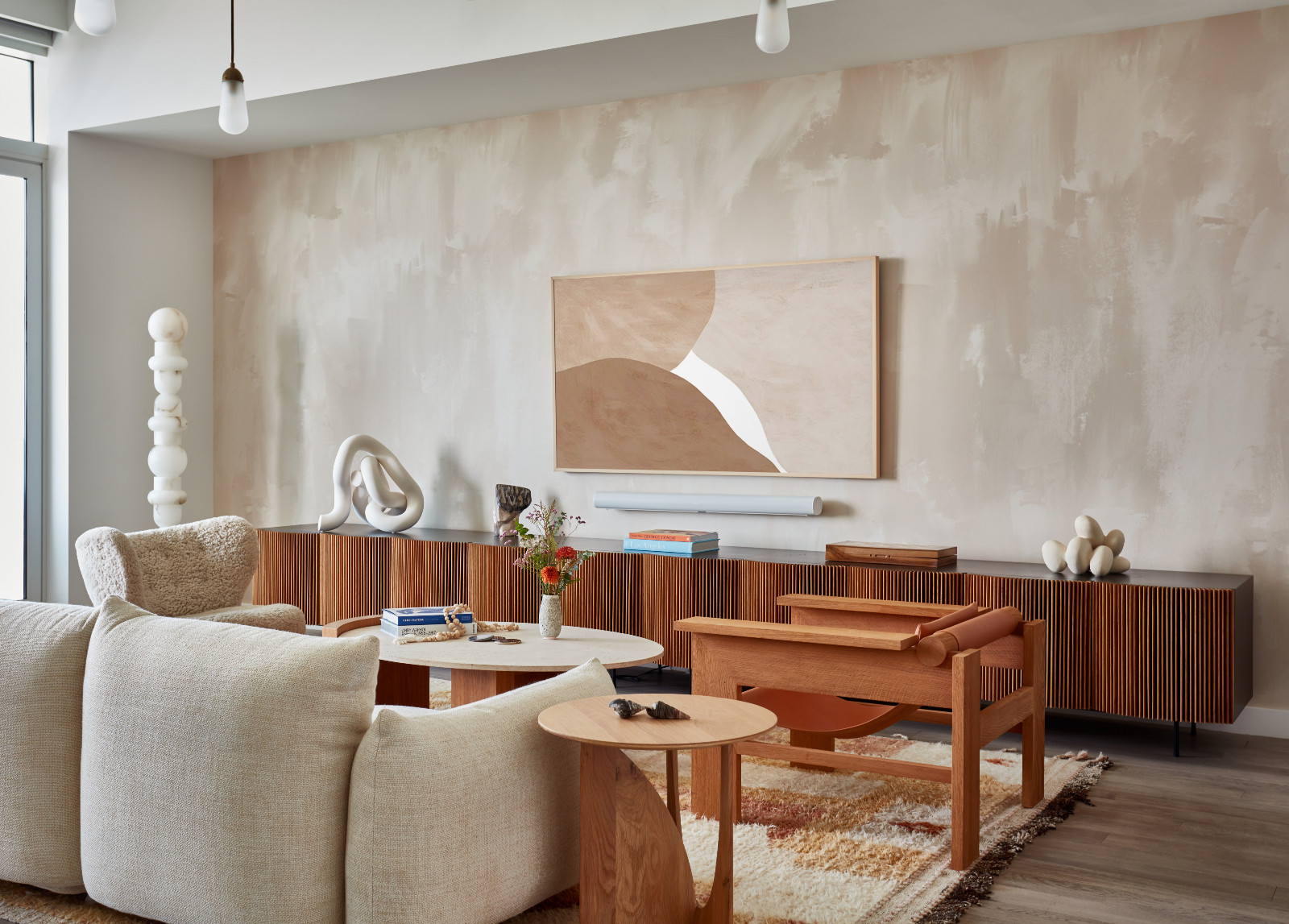 The living room of a young beauty entrepreneur's apartment in Los Angeles, designed by The Scale Collective