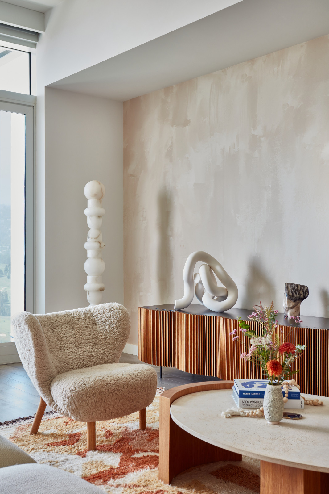The living room of a young beauty entrepreneur's apartment in Los Angeles, designed by The Scale Collective