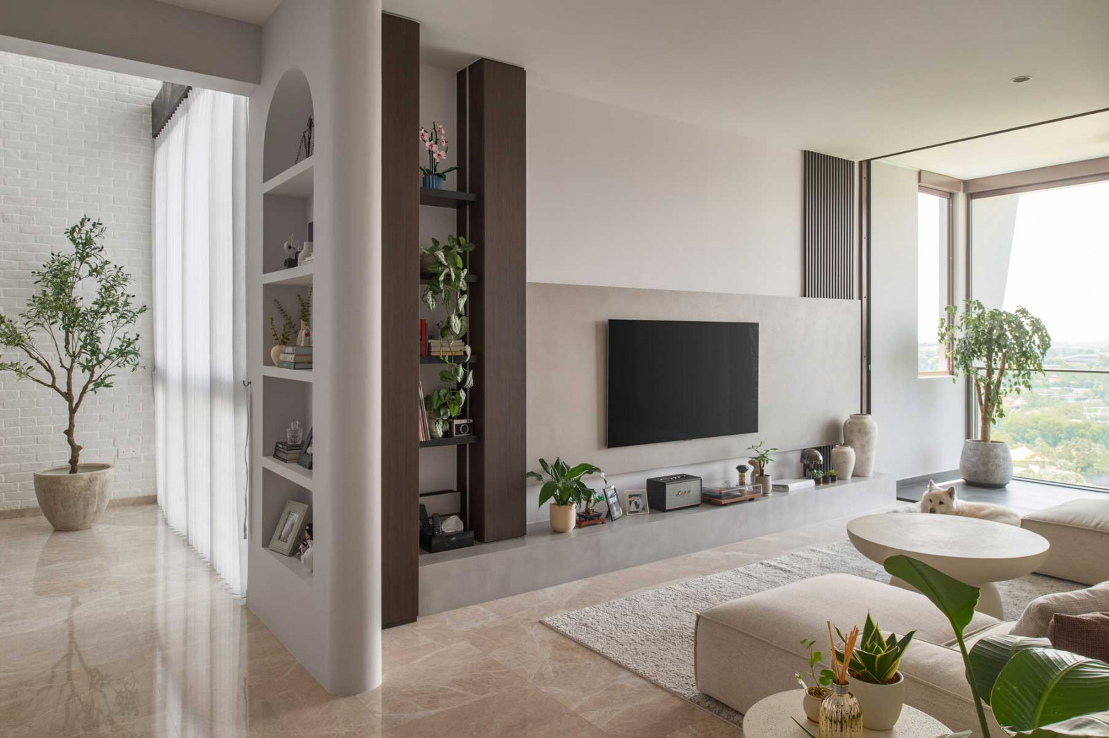 Potted plants infuse the entryway and living room with colour and a sense of freshness