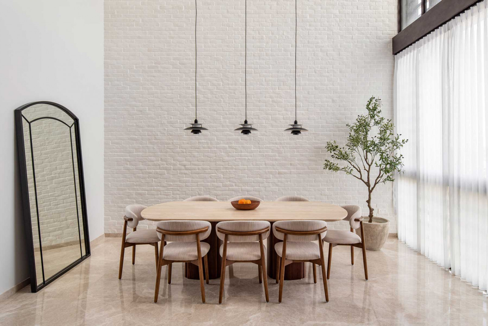 Black accents add a modern edge to the predominantly light dining area