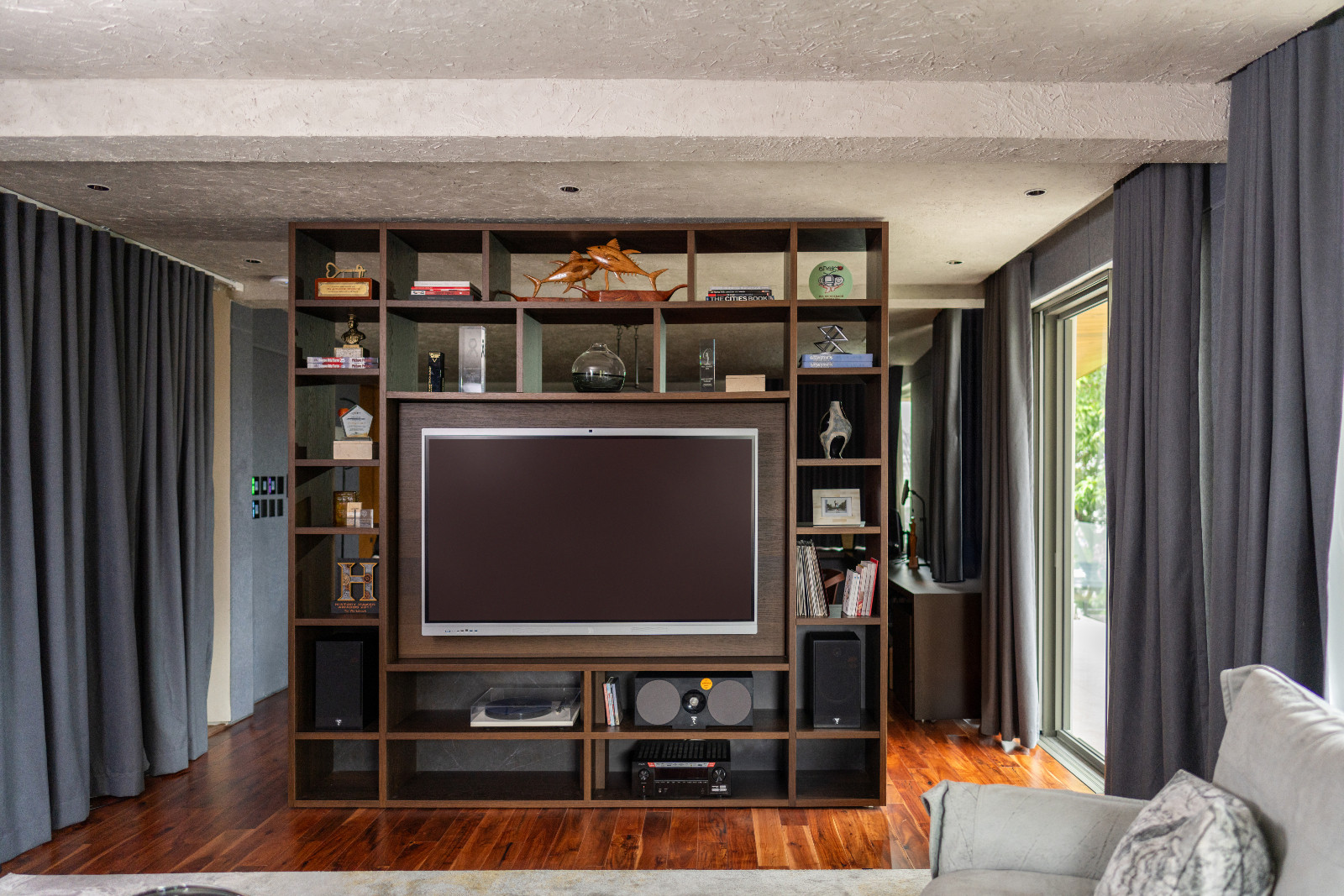 Bespoke Pianca shelving system separates the living and dining space of the man cave in Pia Wurtzbach Jauncey's home